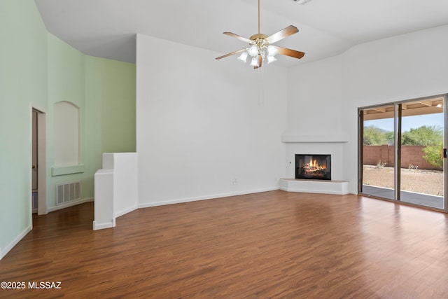 unfurnished living room featuring high vaulted ceiling, a ceiling fan, wood finished floors, and visible vents