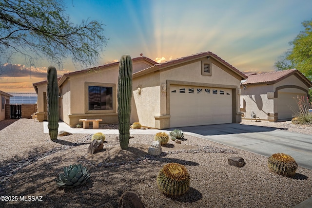 12489 N Owl Head Canyon Rd, Marana, AZ 85658 - ranch-style house featuring concrete driveway, an attached garage, a tile roof, and stucco siding