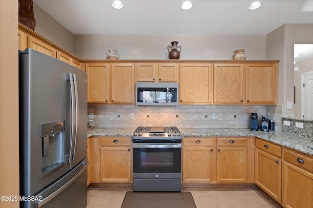 12489 N Owl Head Canyon Rd, Marana, AZ 85658 - kitchen featuring recessed lighting, appliances with stainless steel finishes, backsplash, and light stone countertops