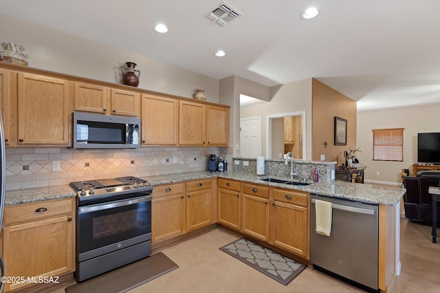 12489 N Owl Head Canyon Rd, Marana, AZ 85658 - kitchen with a sink, stainless steel appliances, open floor plan, a peninsula, and visible vents