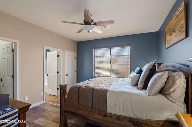 12489 N Owl Head Canyon Rd, Marana, AZ 85658 - bedroom featuring baseboards, ceiling fan, wood finished floors, and visible vents