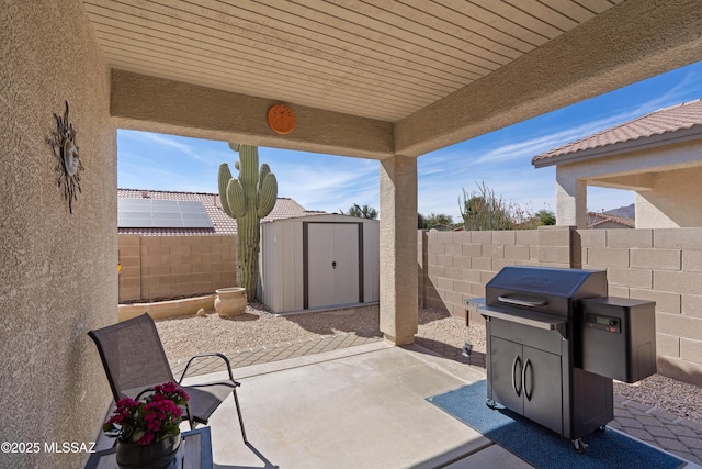 12489 N Owl Head Canyon Rd, Marana, AZ 85658 - view of patio with a fenced backyard, a storage unit, and an outbuilding