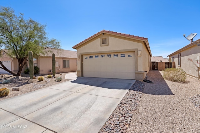 12489 N Owl Head Canyon Rd, Marana, AZ 85658 - view of front of house featuring fence, an attached garage, stucco siding, a tiled roof, and driveway