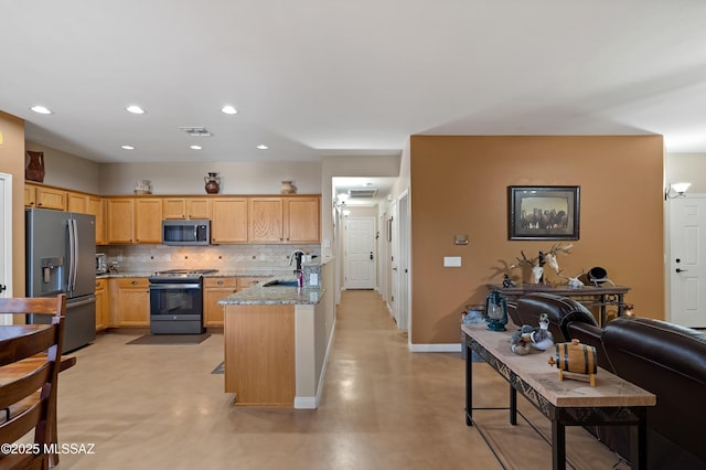 12489 N Owl Head Canyon Rd, Marana, AZ 85658 - kitchen featuring visible vents, a peninsula, tasteful backsplash, a sink, and stainless steel appliances