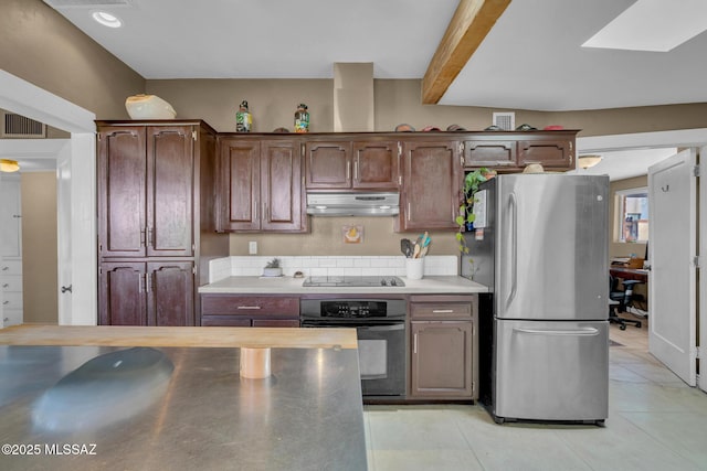 2716 E 6th St, Tucson, AZ 85716 - kitchen with black appliances, under cabinet range hood, light countertops, and light tile patterned flooring