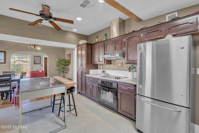 2716 E 6th St, Tucson, AZ 85716 - kitchen with black appliances, arched walkways, under cabinet range hood, light countertops, and ceiling fan