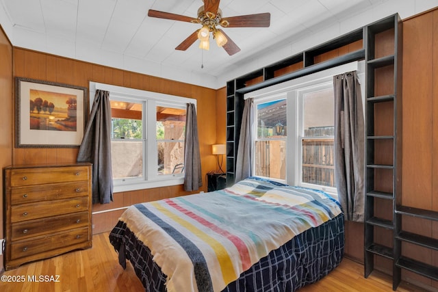 2716 E 6th St, Tucson, AZ 85716 - bedroom featuring wood finished floors, wooden walls, and ceiling fan