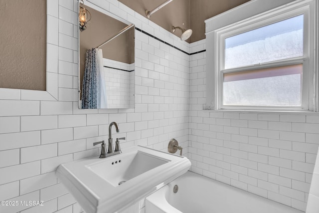 2716 E 6th St, Tucson, AZ 85716 - bathroom with a sink, tile walls, and shower / bath combo