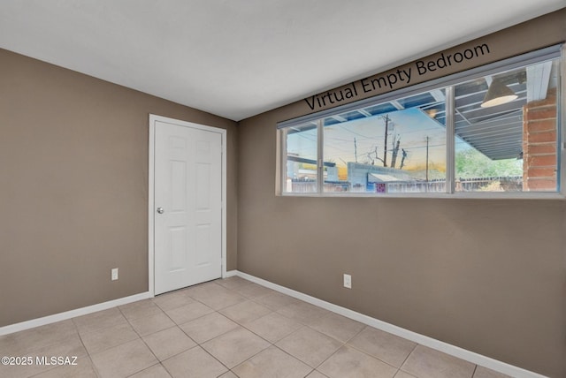 2716 E 6th St, Tucson, AZ 85716 - empty room featuring baseboards, plenty of natural light, light tile patterned flooring, and vaulted ceiling