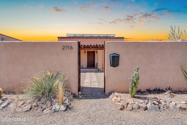 2716 E 6th St, Tucson, AZ 85716 - exterior entry at dusk with stucco siding