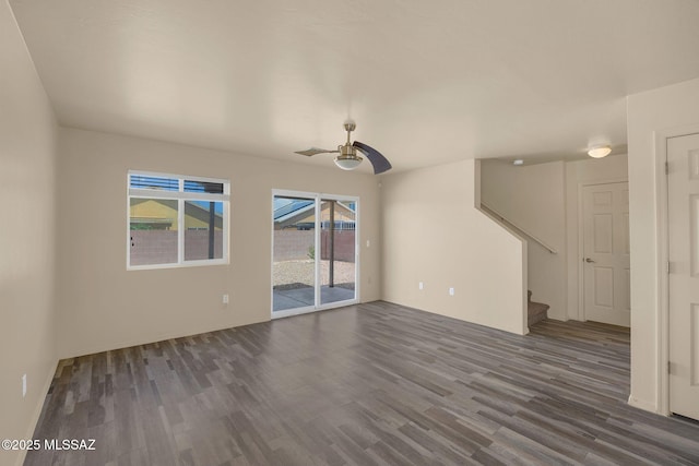 891 E Emma Maria St, Tucson, AZ 85706 - unfurnished living room with ceiling fan, stairs, and wood finished floors