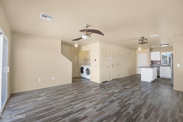 891 E Emma Maria St, Tucson, AZ 85706 - unfurnished living room featuring dark wood-type flooring, independent washer and dryer, visible vents, and a ceiling fan