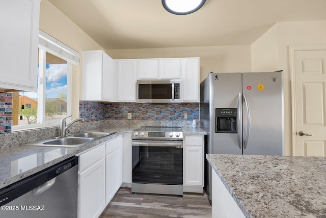 891 E Emma Maria St, Tucson, AZ 85706 - kitchen featuring wood finished floors, appliances with stainless steel finishes, white cabinetry, and a sink