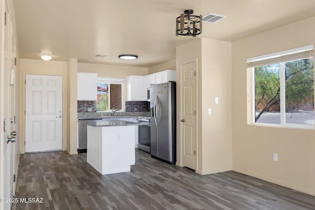 891 E Emma Maria St, Tucson, AZ 85706 - kitchen featuring white cabinets, stainless steel appliances, dark wood-style floors, visible vents, and a kitchen island