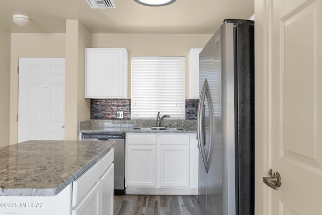 891 E Emma Maria St, Tucson, AZ 85706 - kitchen featuring wood finished floors, visible vents, a sink, appliances with stainless steel finishes, and white cabinetry