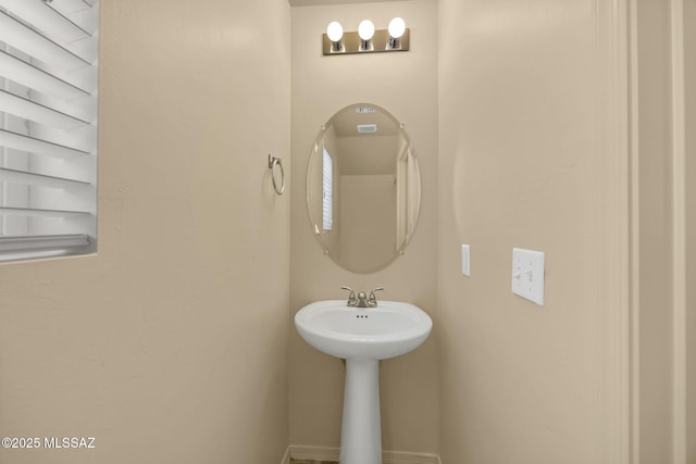 891 E Emma Maria St, Tucson, AZ 85706 - bathroom featuring baseboards and a sink