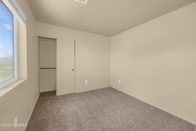 891 E Emma Maria St, Tucson, AZ 85706 - unfurnished bedroom with a closet, multiple windows, visible vents, and carpet