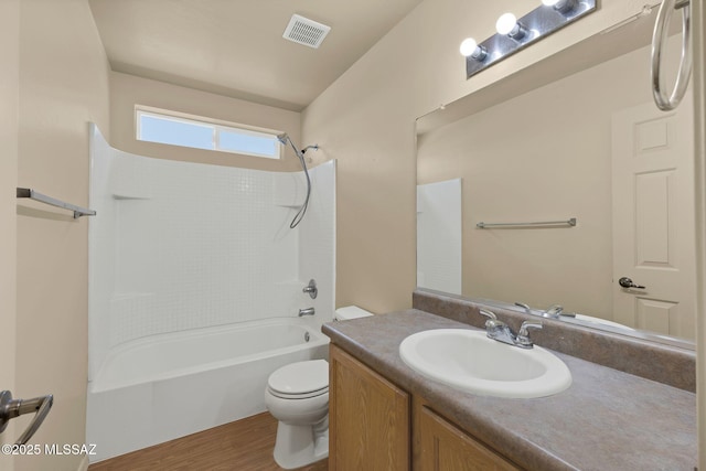 891 E Emma Maria St, Tucson, AZ 85706 - bathroom with toilet, shower / bathing tub combination, visible vents, wood finished floors, and vanity