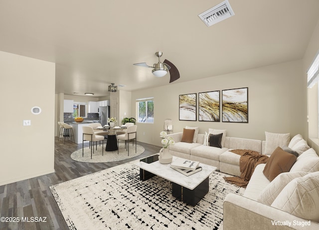 891 E Emma Maria St, Tucson, AZ 85706 - living room featuring baseboards, visible vents, a ceiling fan, and dark wood-style floors