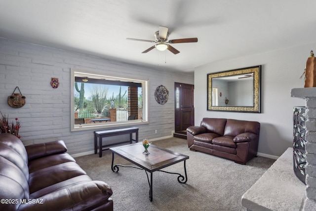 carpeted living room featuring baseboards and ceiling fan
