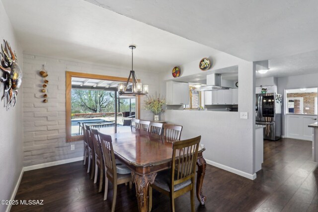 dining room featuring baseboards and dark wood-type flooring