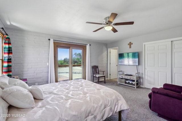 bedroom featuring a ceiling fan, brick wall, access to exterior, carpet floors, and a closet