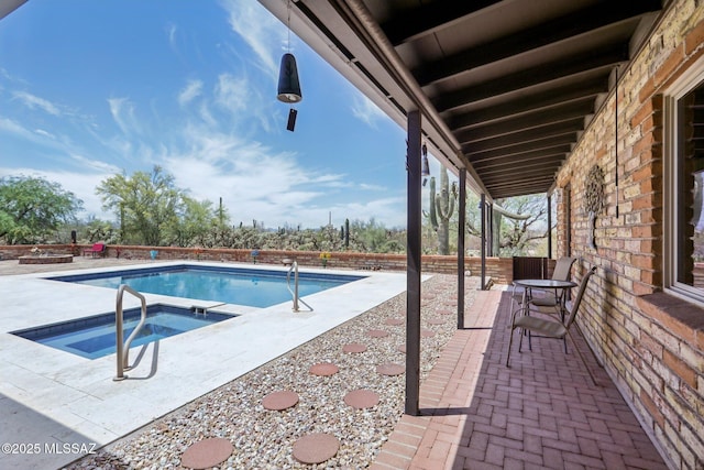 view of pool featuring a fenced in pool, a patio, and an in ground hot tub
