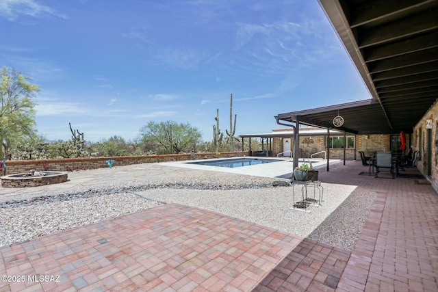 view of pool with a patio, a fenced in pool, and an outdoor fire pit