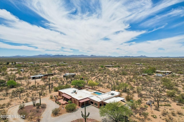 birds eye view of property with a mountain view and view of desert