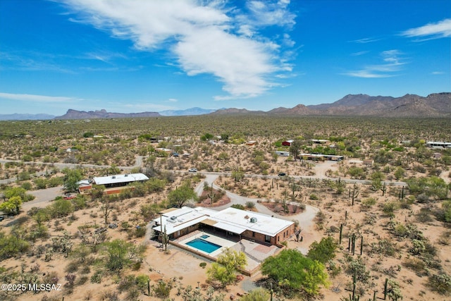 drone / aerial view featuring a desert view and a mountain view