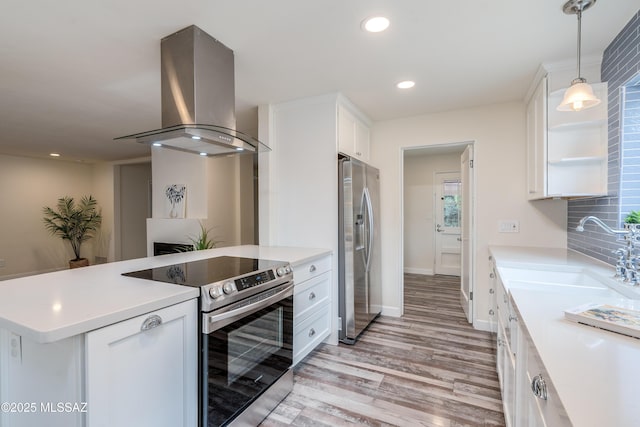 38 N Irving Ave, Tucson, AZ 85711 - kitchen with stainless steel appliances, island range hood, a sink, light wood-style floors, and white cabinetry