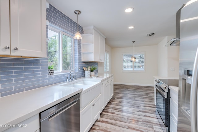 38 N Irving Ave, Tucson, AZ 85711 - kitchen with white cabinets, baseboards, stainless steel appliances, and a sink
