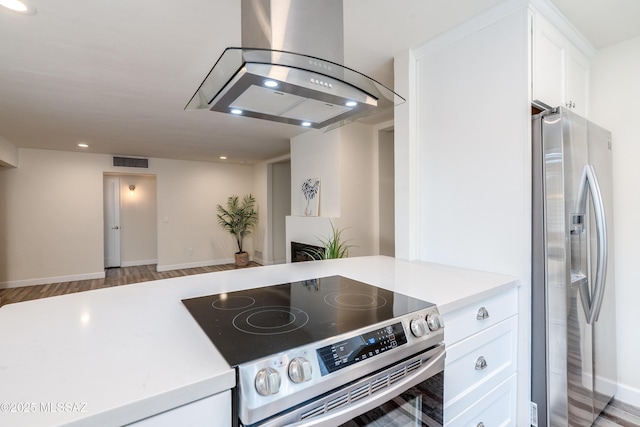 38 N Irving Ave, Tucson, AZ 85711 - kitchen with ventilation hood, stainless steel appliances, light countertops, visible vents, and white cabinetry