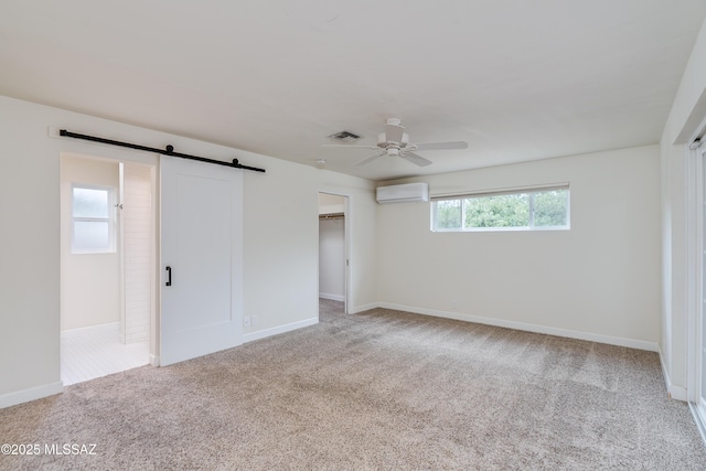 38 N Irving Ave, Tucson, AZ 85711 - unfurnished bedroom featuring visible vents, an AC wall unit, carpet, and a barn door