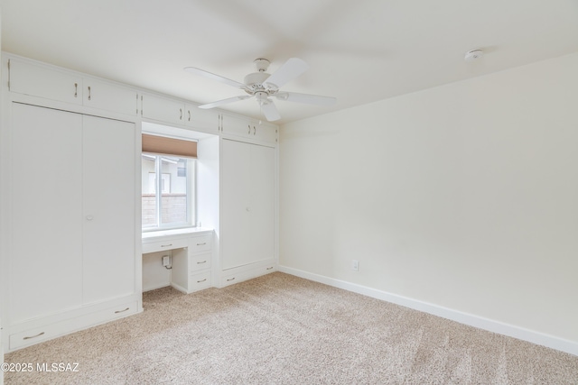 38 N Irving Ave, Tucson, AZ 85711 - unfurnished bedroom with light colored carpet, baseboards, and a ceiling fan