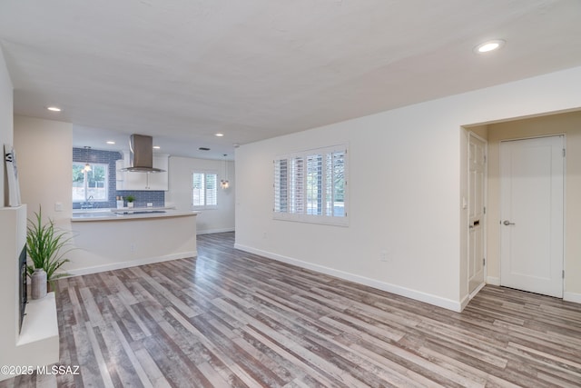 38 N Irving Ave, Tucson, AZ 85711 - unfurnished living room with baseboards, wood finished floors, and recessed lighting