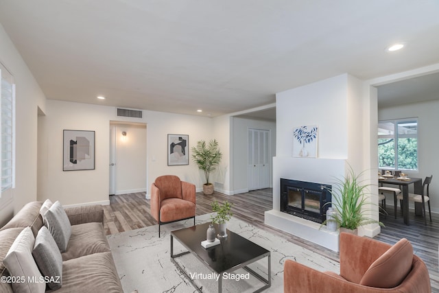 38 N Irving Ave, Tucson, AZ 85711 - living room featuring recessed lighting, wood finished floors, visible vents, baseboards, and a glass covered fireplace