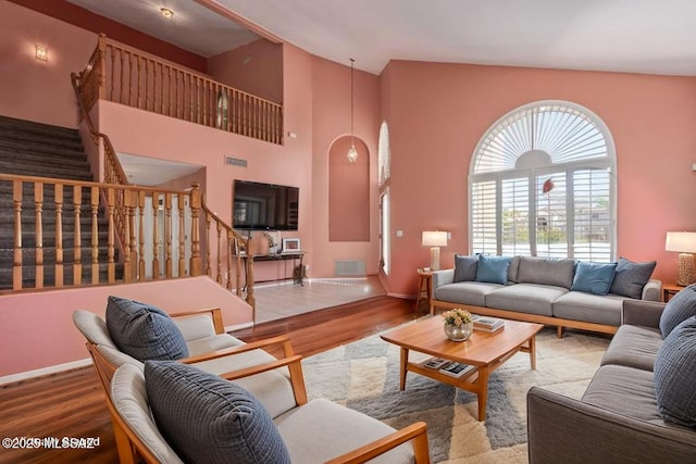 3762 W Meadow Briar Dr, Tucson, AZ 85741 - living area featuring stairs, wood finished floors, baseboards, and high vaulted ceiling
