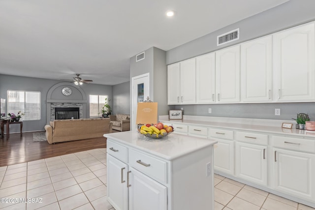 kitchen with light tile patterned flooring, visible vents, a ceiling fan, and light countertops