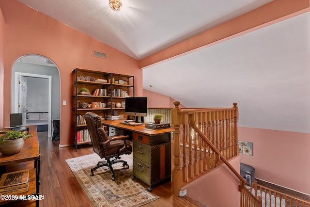 home office with lofted ceiling, wood finished floors, and visible vents