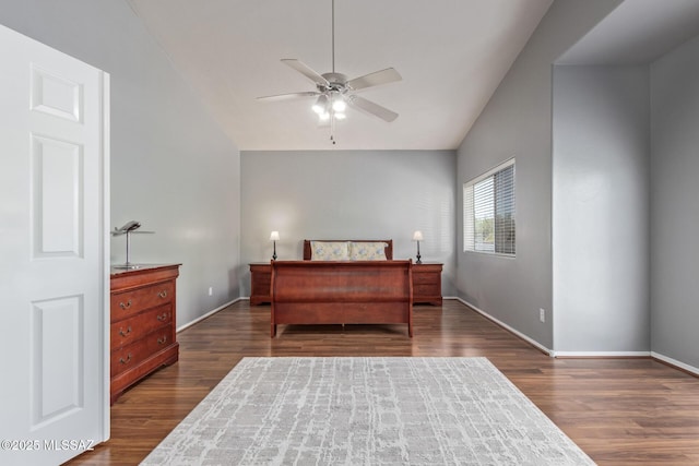 bedroom featuring baseboards, vaulted ceiling, and dark wood finished floors