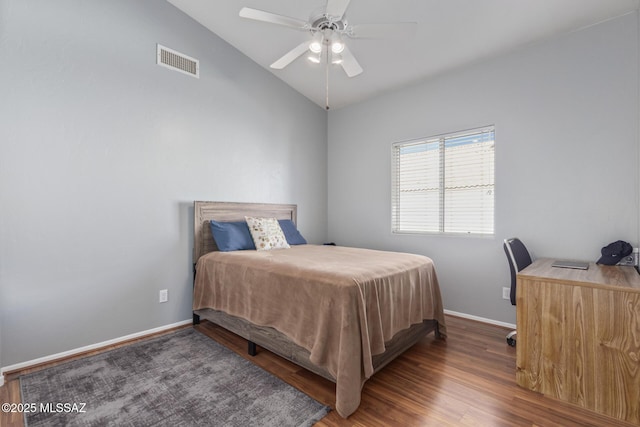 bedroom with ceiling fan, lofted ceiling, visible vents, baseboards, and wood finished floors