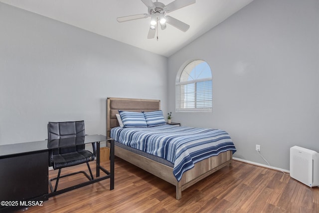 bedroom with a ceiling fan, wood finished floors, lofted ceiling, and baseboards