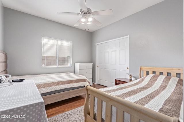 bedroom featuring a closet, a ceiling fan, and wood finished floors