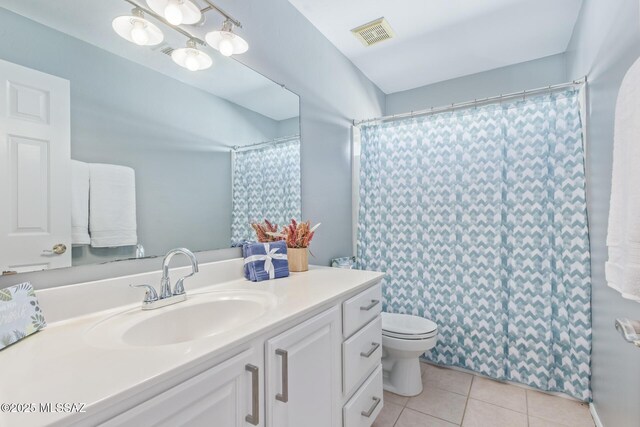 bathroom with tile patterned floors, toilet, curtained shower, vanity, and visible vents