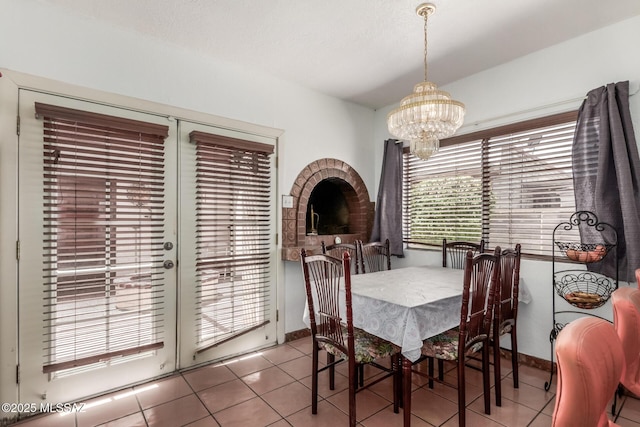 414 E 34th St, Tucson, AZ 85713 - tiled dining area with baseboards and a chandelier
