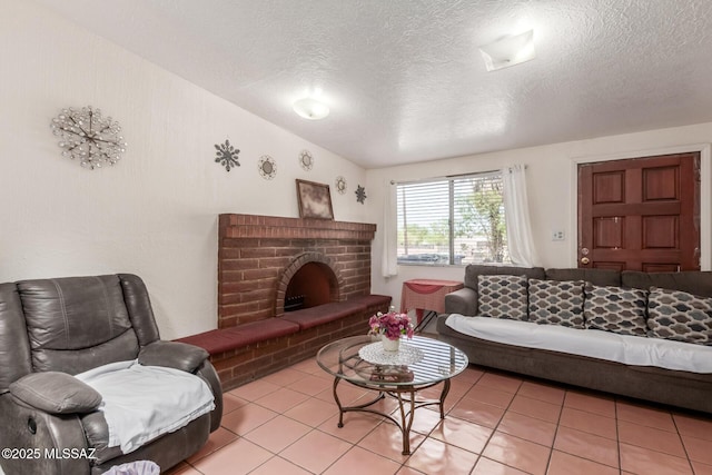 414 E 34th St, Tucson, AZ 85713 - living room with light tile patterned floors, a brick fireplace, and a textured ceiling