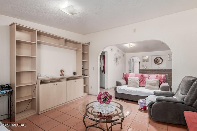 414 E 34th St, Tucson, AZ 85713 - living area with arched walkways, a textured ceiling, and light tile patterned flooring