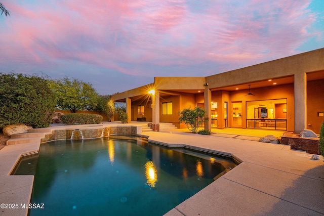 5327 N Ventana Overlook Pl, Tucson, AZ 85750 - pool at dusk featuring a ceiling fan, a patio, and an outdoor pool