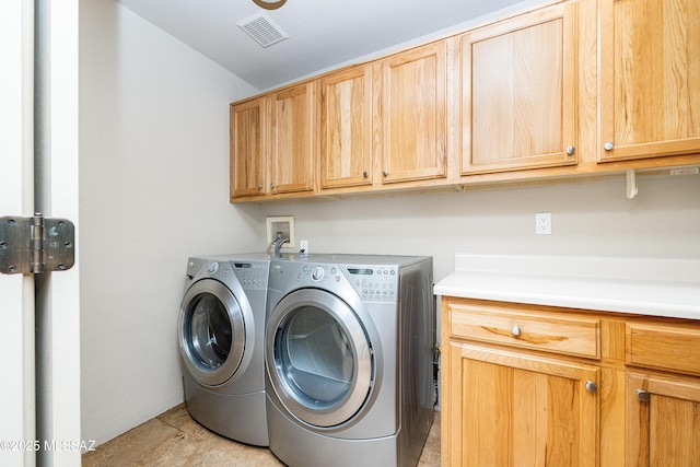 5327 N Ventana Overlook Pl, Tucson, AZ 85750 - washroom with cabinet space, visible vents, light tile patterned floors, and washing machine and clothes dryer